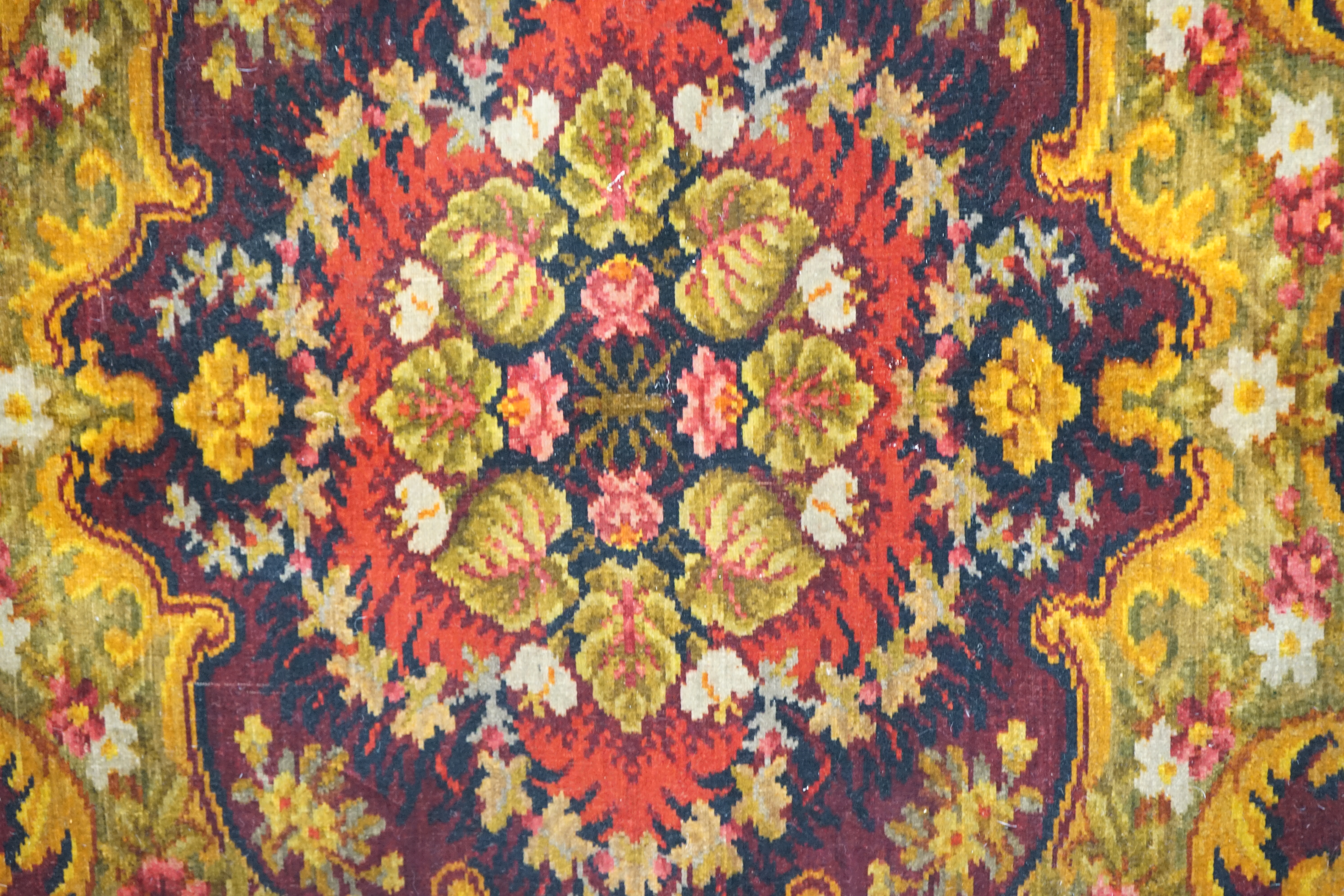 An Edwardian table cover in brightly coloured wools, with a floral design, together with a later 20th century continental grey, beige and cream patterned silk cover, Edwardian table cover 220cm x 172cm. Condition - colou